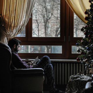 Homme près de son sapin, prenant soin de lui pour les fêtes de noël et l'hivers